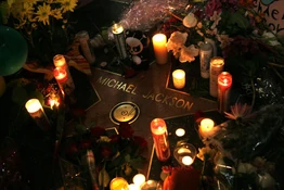 's star on The Hollywood Walk of Fame surrounded by flowers and candles as a memorial to him.