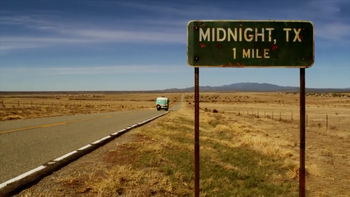 Midnight Texas highway sign