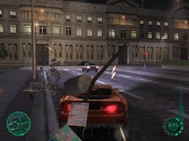 A Jersey XS destroys a lamppost in the in-game city of Paris. A large building can be seen in the background.