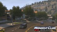 This is a screenshot of some traffic cars driving in the hills of Los Angeles (possibly the hills in upper Hollywood).