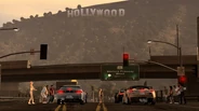 A race is about to begin in in-game Los Angeles. The Hollywood Sign can be seen in the background.