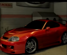 Oscar's Garage Supra.png (440 KB) A modified Toyota Supra in Oscar's garage in the career mode opening scene