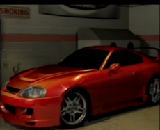 A modified Toyota Supra in Oscar's garage in the career mode opening scene