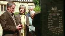Tom looking into his wallet after reading admission for the Memorial Garden