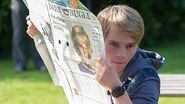 Dan undercover with a picture of 'Evelyn Baxter' on a newspaper.