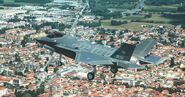 A F-35B of the Italian Navy flying over a city