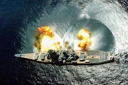 USS Iowa (BB-61) fires a broadside of nine 16"/50 and six 5"/38 guns during an exercise
