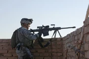 A U.S. Army sniper with Bravo Company, ,  stands ready to engage targets during a mission on the outskirts of Baghdad, Iraq.