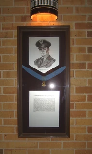 Photo of Carswell and a Medal of Honor on exhibit at Texas A&M University'"`UNIQ--ref-00000003-QINU`"'