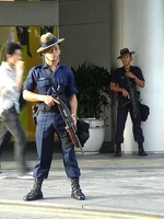 A  trooper in Singapore armed with a  folding stock pump shotgun