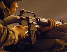 Close-up detail view of the magazine, ejection port and carrying handle of a Colt M16A2 rifle
