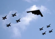 A B-2 in formation flight with eight U.S