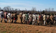 Reenactors portraying Colonial troops march into battle at Cowpens