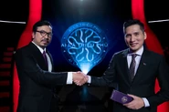Quốc Khánh (right) shake his hands with former host Đinh Tiến Dũng