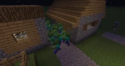 A group of zombies swarming a villager's home