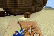 A buried treasure chest that naturally generated on land next to a Shipwreck