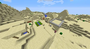 Um templo do deserto gerado em parte sob a areia com uma aldeia do deserto gerando perto dele.