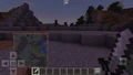 Holding a map in the offhand in Bedrock Edition.