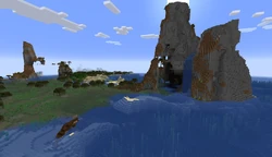 A cove beneath a large rock outcrop.
