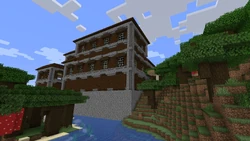 A woodland mansion next to a river.