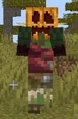 A savanna zombie villager wearing a carved pumpkin.
