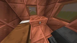 A large copper chest inside the copper house.