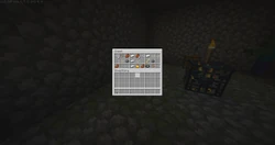 A chest in a monster room that is open, revealing loot.