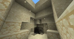 A lot of sand floating above a cave enterance.