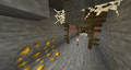 Redstone ore in a mine with a diamond ore (bottom right) and a vein of iron ore (bottom left) next to it.