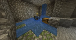 A monster room with a waterfall flowing into it.