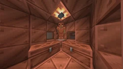 Two large copper chests with an armor stand equipped with copper gear in the corner.