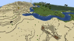 A desert village with a partially buried desert pyramid.