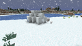 An igloo on the shore of a frozen lake, with some polar bears.