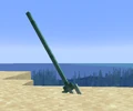 A trident stuck in sand.