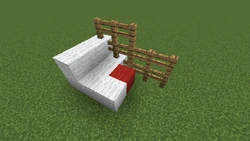 Mobs can jump onto this fence because of the red wool. Remove the red wool or replace the adjacent fence with a solid block.