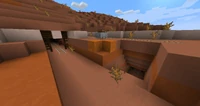An exposed mineshaft in a mesa biome.