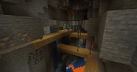An abandoned mineshaft with wooden bridges crossing over a ravine.
