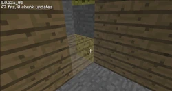 Hidden sponge in the corner of a wood-paneled room, in Java Edition Classic.