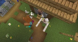 An iron golem killing a zombie during a siege, preventing the zombie from breaking down the door.