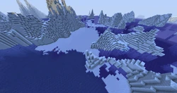 An aerial view of a frozen ocean with icebergs.
