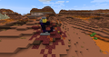 Ruined portal in Badlands biome with a mineshaft behind it.