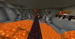 A zombie being pushed by a snowball on the lava bridge.