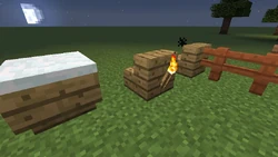 Stairs with snow, torches and fences connecting to them.