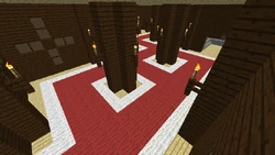 An example of a large hallway, with multiple branching directions, supported by two large wooden pillars. torches are in top of the fences to express that it is hanging.