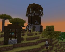 A few allays trapped in a cage in a savanna outpost in Bedrock Edition.