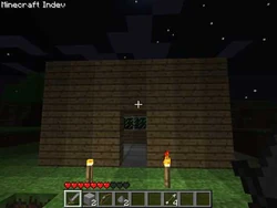 A wooden indev house at night.