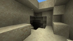 Sand floating above a desert cave entrance.