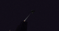 An ender dragon being hit with the "healing beam" of an end crystal.