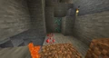 Naturally generated diamond and redstone ores in a cave.