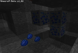A blob of lapis lazuli ore with multiple pieces of lapis on the ground.